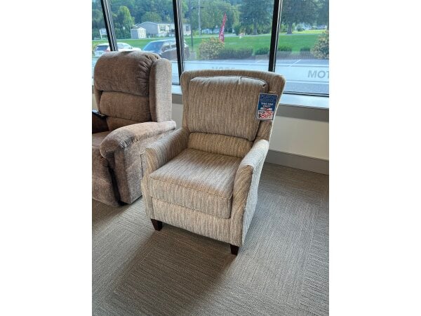 Beige striped armchair on display in a furniture showroom.