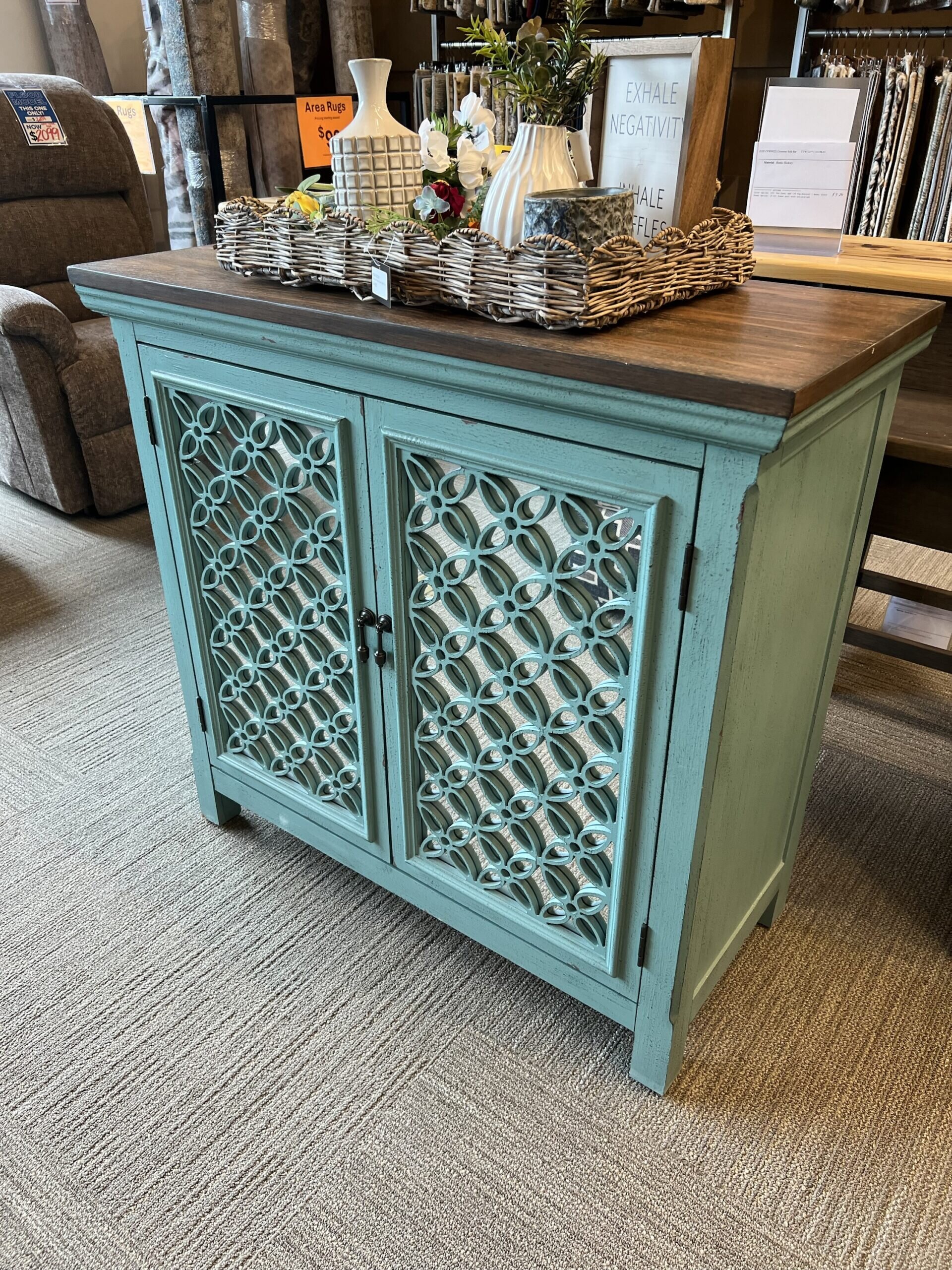img_9610 Teal accent cabinet with mirrored lattice doors and wooden top.