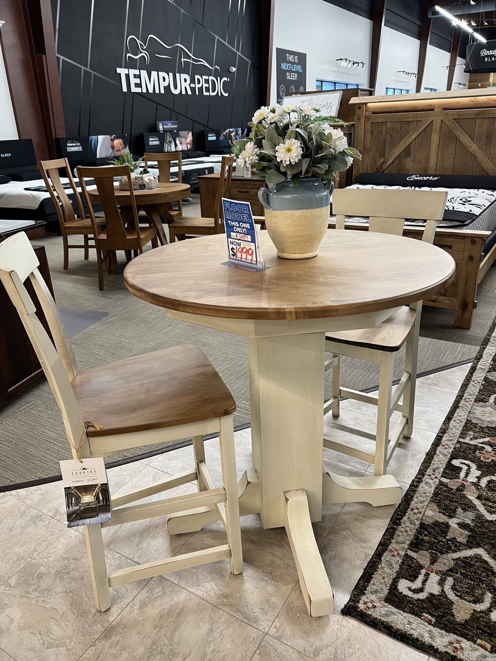 img_9702 Round wood dining table with two cream-colored chairs on sale.